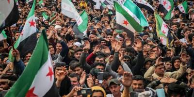 Şam'da devrimin başlangıç yıl dönümü ilk kez kutlandı, helikopterlerle halka gül dağıtıldı